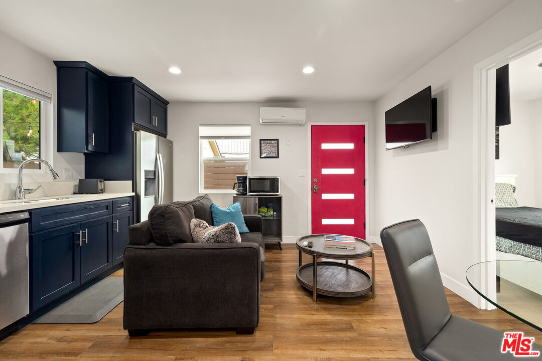 5325 9th Avenue, Unit 5327 Los Angeles, CA 90043 - Photo 2 of 11 a living room with furniture and a flat screen tv