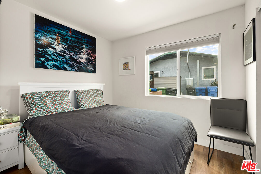 5325 9th Avenue, Unit 5327 Los Angeles, CA 90043 - Photo 6 of 11 a bedroom with a bed and a chair