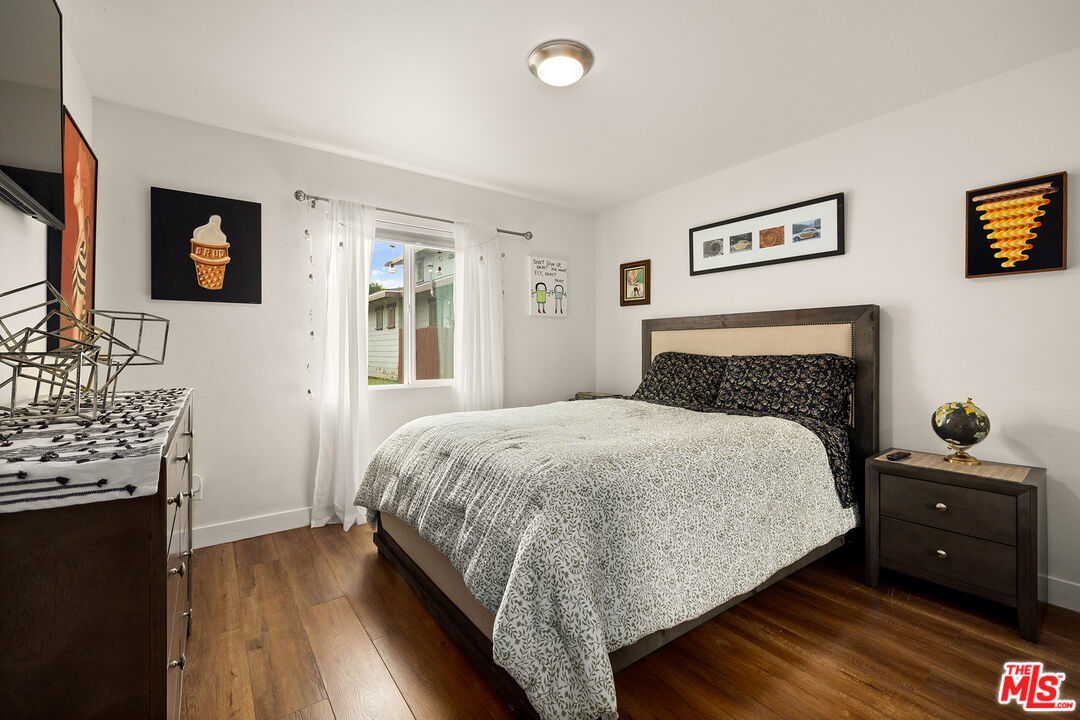 5325 9th Avenue, Unit 5327 Los Angeles, CA 90043 - Photo 7 of 11 a bedroom with a bed and a fireplace