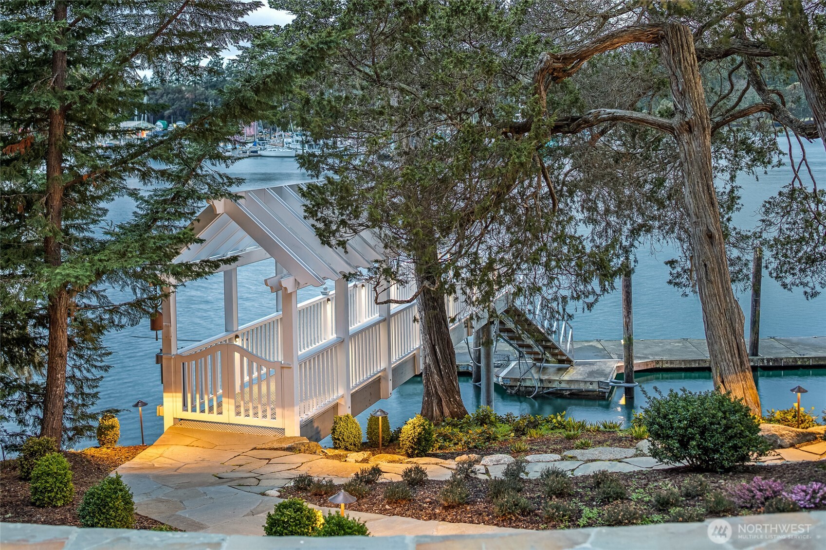 95 Laurel Point Lane Friday Harbor, WA 98250 - Photo 4 of 40 a view of a white house next to a road with large trees