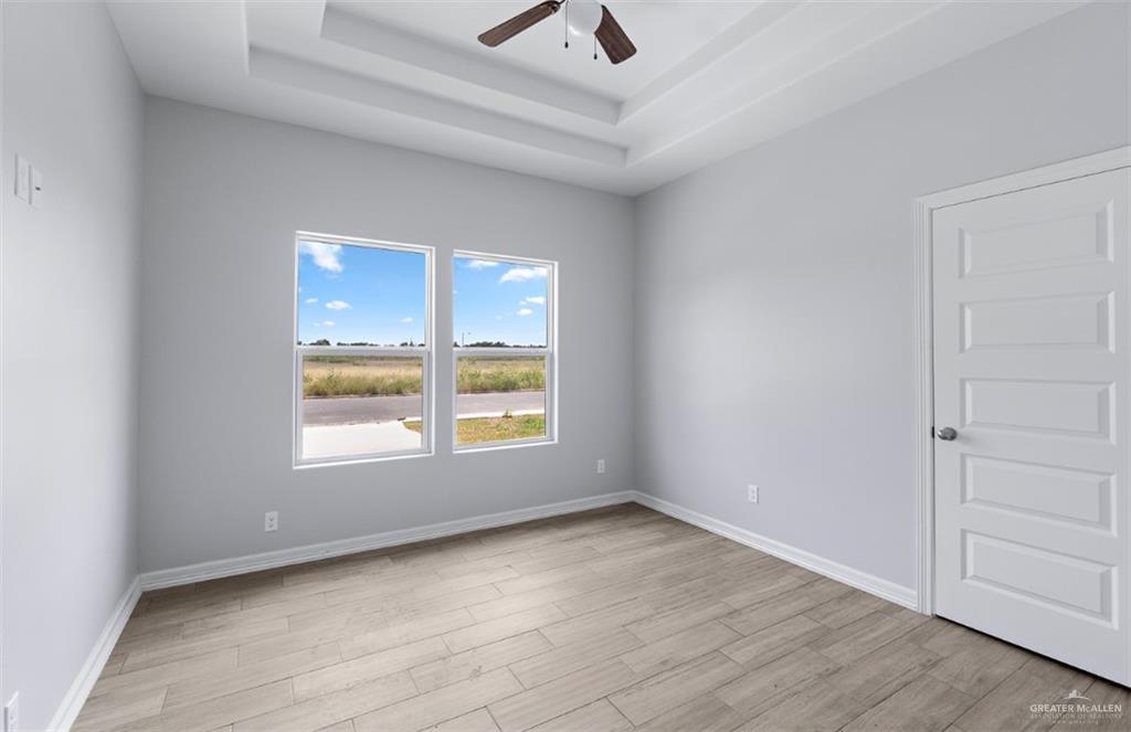 508 Bridget Street Weslaco, TX 78596 - Photo 14 of 19 an empty room with a window and a ceiling fan