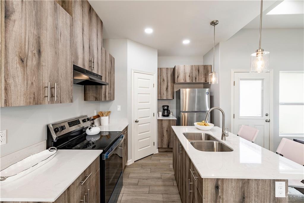 508 Bridget Street Weslaco, TX 78596 - Photo 3 of 19 a kitchen that has a sink a stove and a refrigerator