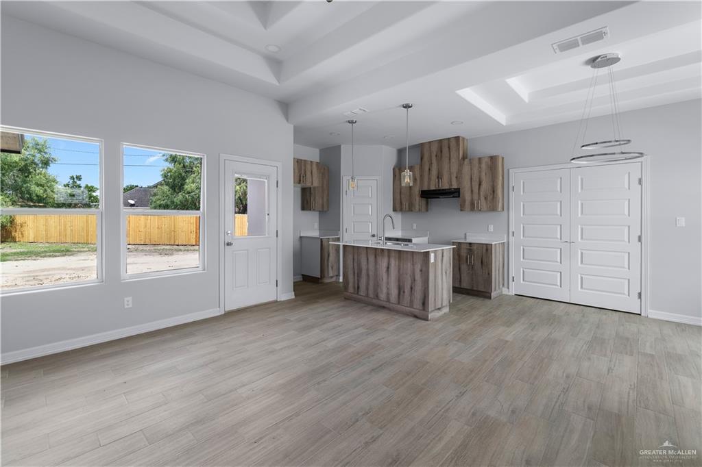 508 Bridget Street Weslaco, TX 78596 - Photo 6 of 19 an empty room with wooden floor and windows