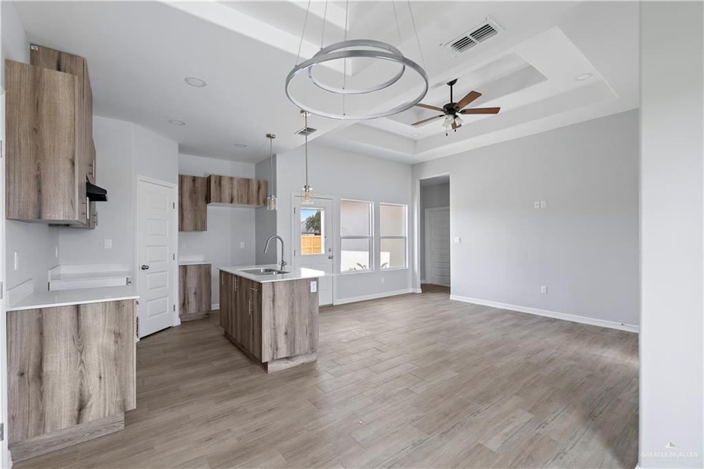508 Bridget Street Weslaco, TX 78596 - Photo 8 of 19 a view of a kitchen with a sink cabinets and wooden floor