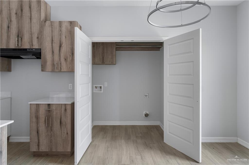 508 Bridget Street Weslaco, TX 78596 - Photo 9 of 19 a view of a room with wooden floor and cabinets