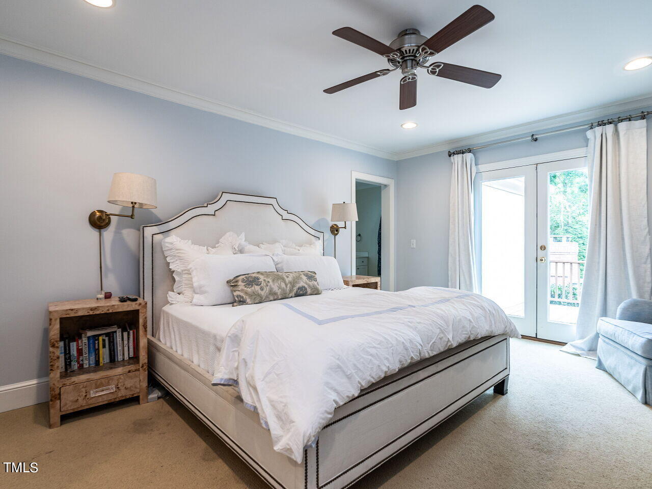 2312 Gaddy Drive Raleigh, NC 27609 - Photo 19 of 32 a bedroom with a bed and a chandelier