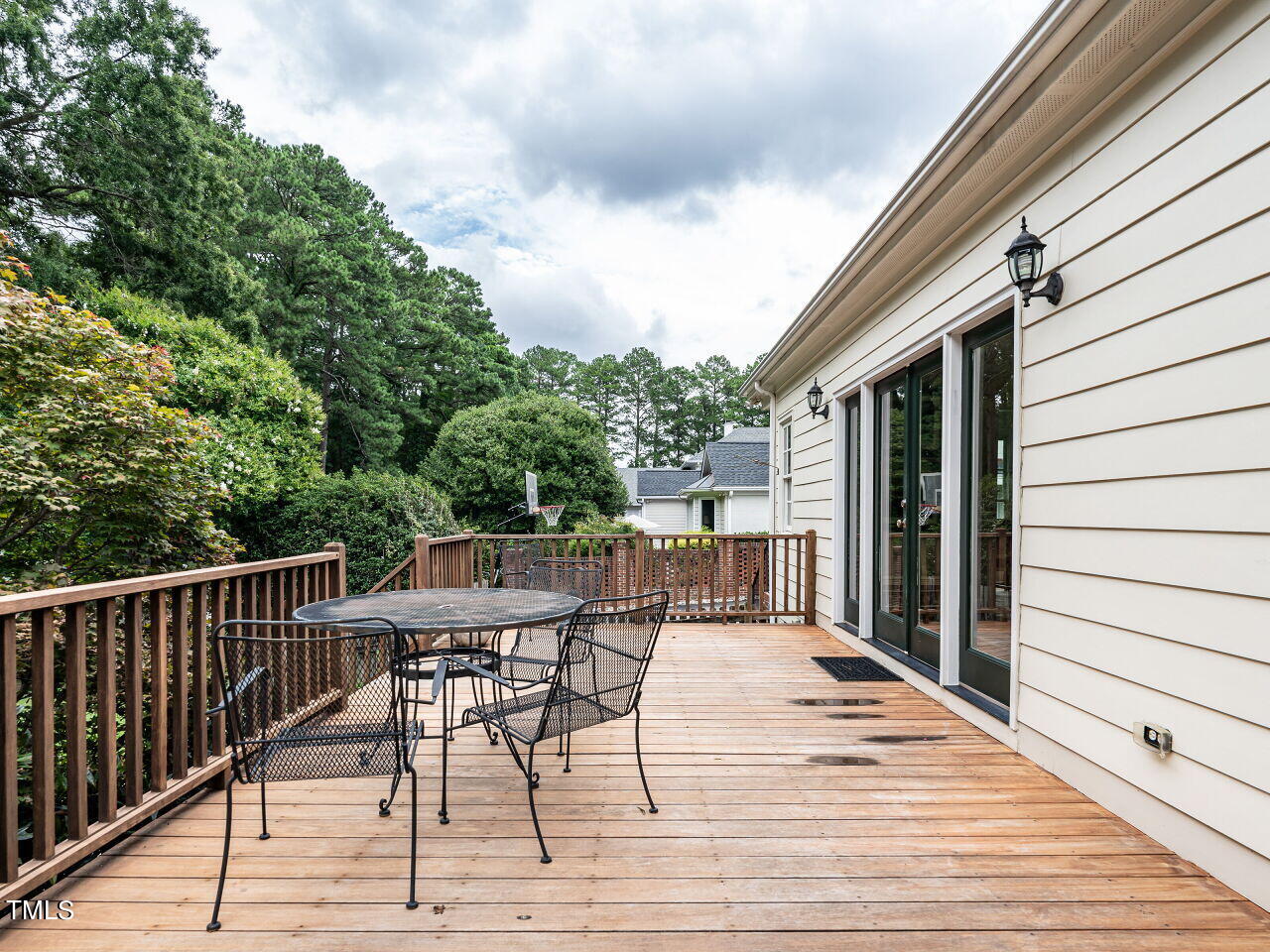 2312 Gaddy Drive Raleigh, NC 27609 - Photo 28 of 32 a view of a patio with a table and chairs and wooden floor