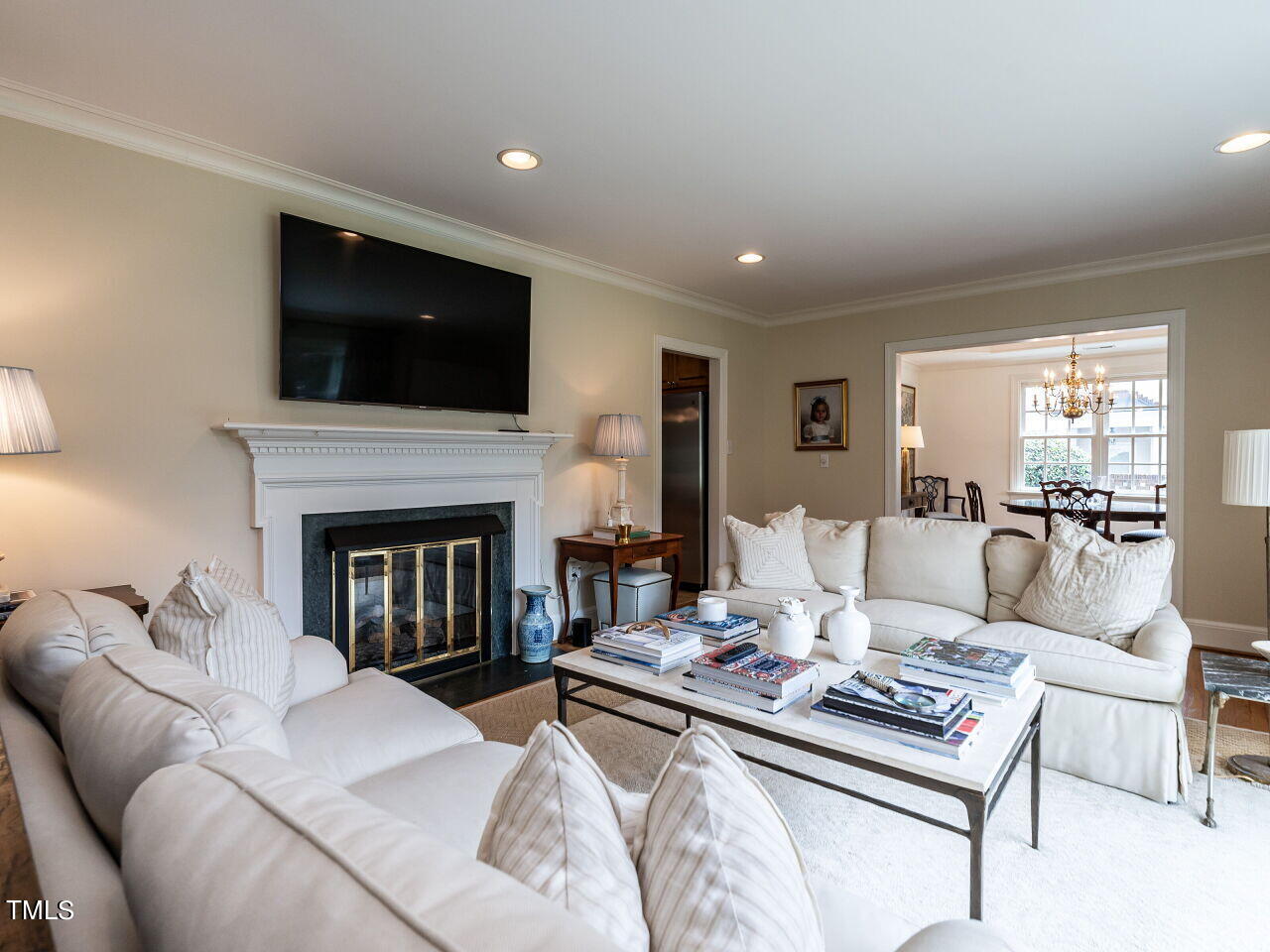 2312 Gaddy Drive Raleigh, NC 27609 - Photo 6 of 32 a living room with furniture a flat screen tv and a fireplace