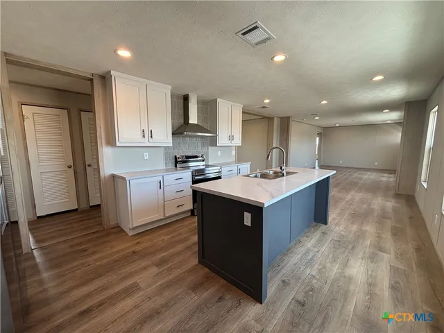 a kitchen with kitchen island cabinets and wooden floor