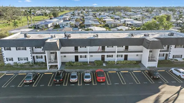 an aerial view of residential houses with outdoor space and parking