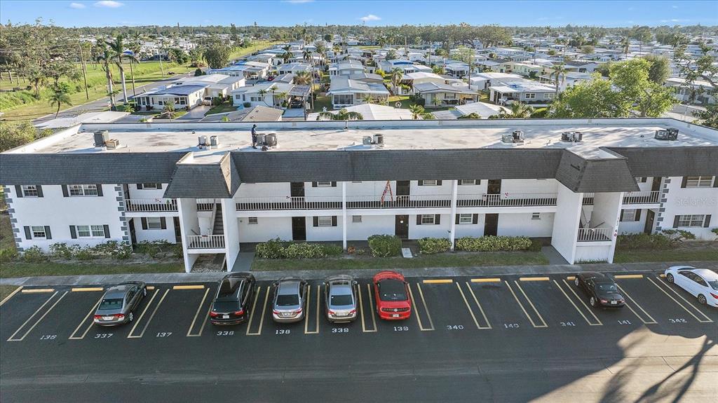 an aerial view of residential houses with outdoor space and parking