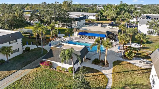 an aerial view of a house with yard swimming pool and outdoor seating