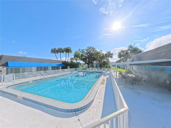 a view of a swimming pool with a yard