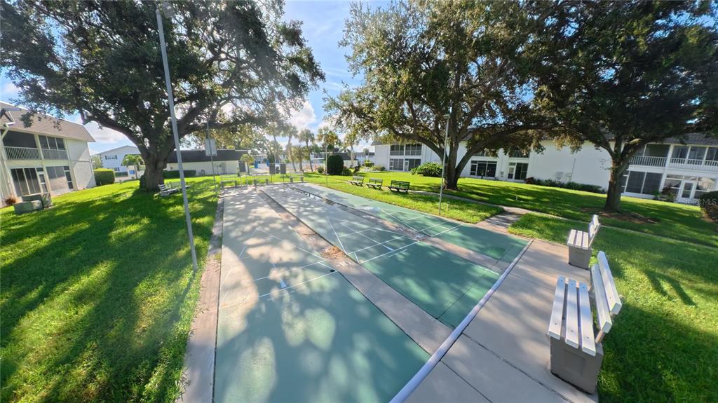 102 47th Ave Drive West, Unit 342 Bradenton, FL 34207 - Photo 20 of 20 a view of a yard with plants and large trees