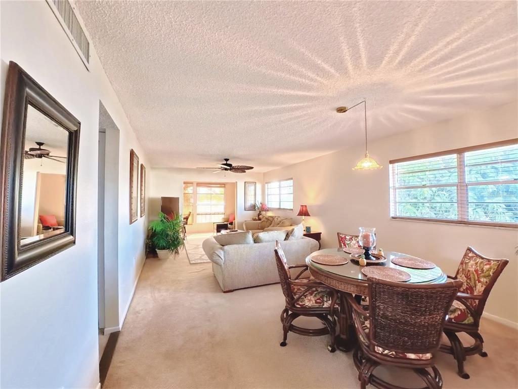 102 47th Ave Drive West, Unit 342 Bradenton, FL 34207 - Photo 3 of 20 a living room with furniture and a large window