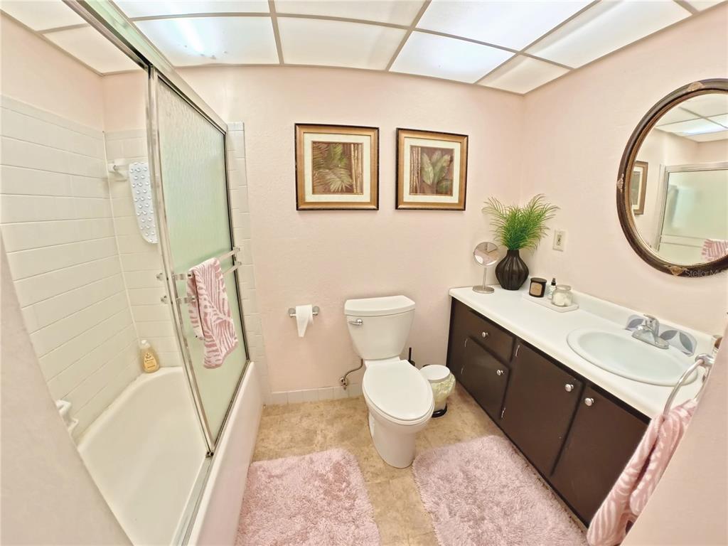 102 47th Ave Drive West, Unit 342 Bradenton, FL 34207 - Photo 9 of 20 a bathroom with a sink a toilet and a mirror