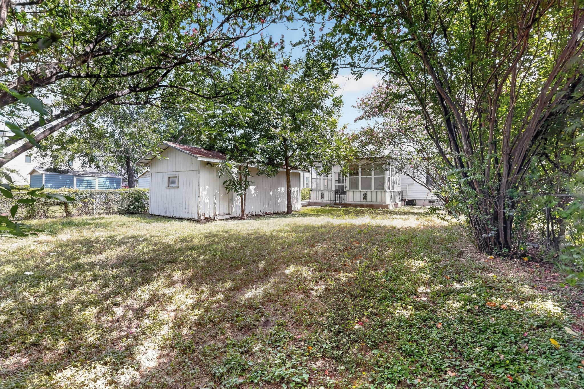 4703 Leslie Avenue Austin, TX 78721 - Photo 33 of 34 A spacious yard with mature trees and a detached shed for extra storage.