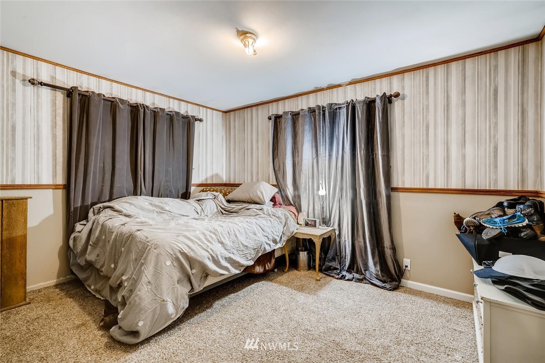 11526 Southeast Petrovitsky Road Renton, WA 98055 - Photo 12 of 28 a bed sitting in a room next to a window