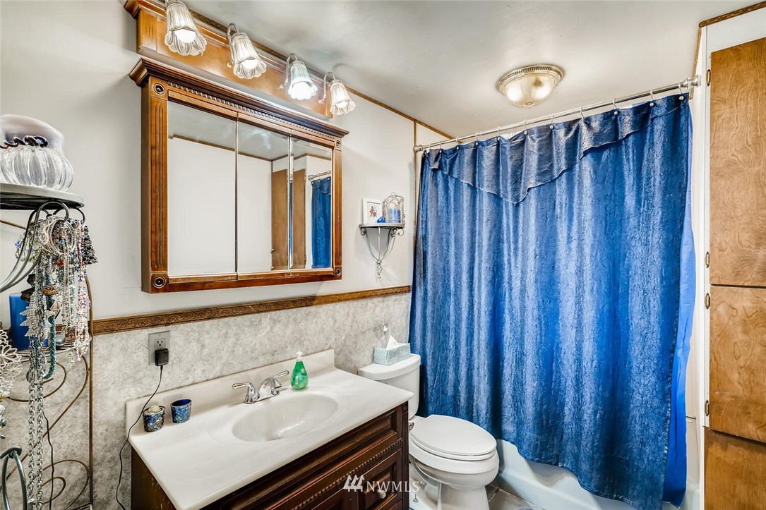 11526 Southeast Petrovitsky Road Renton, WA 98055 - Photo 14 of 28 a bathroom with a sink vanity mirror and toilet