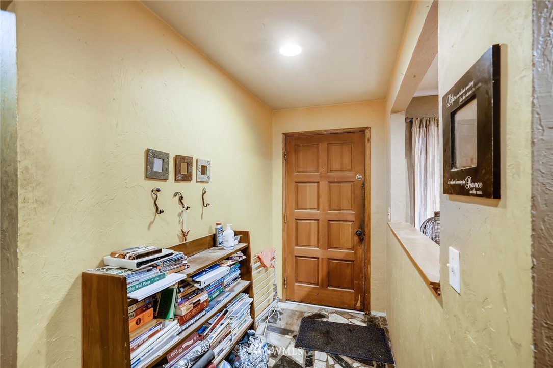 11526 Southeast Petrovitsky Road Renton, WA 98055 - Photo 3 of 28 a view of a hallway with entryway and wooden floor