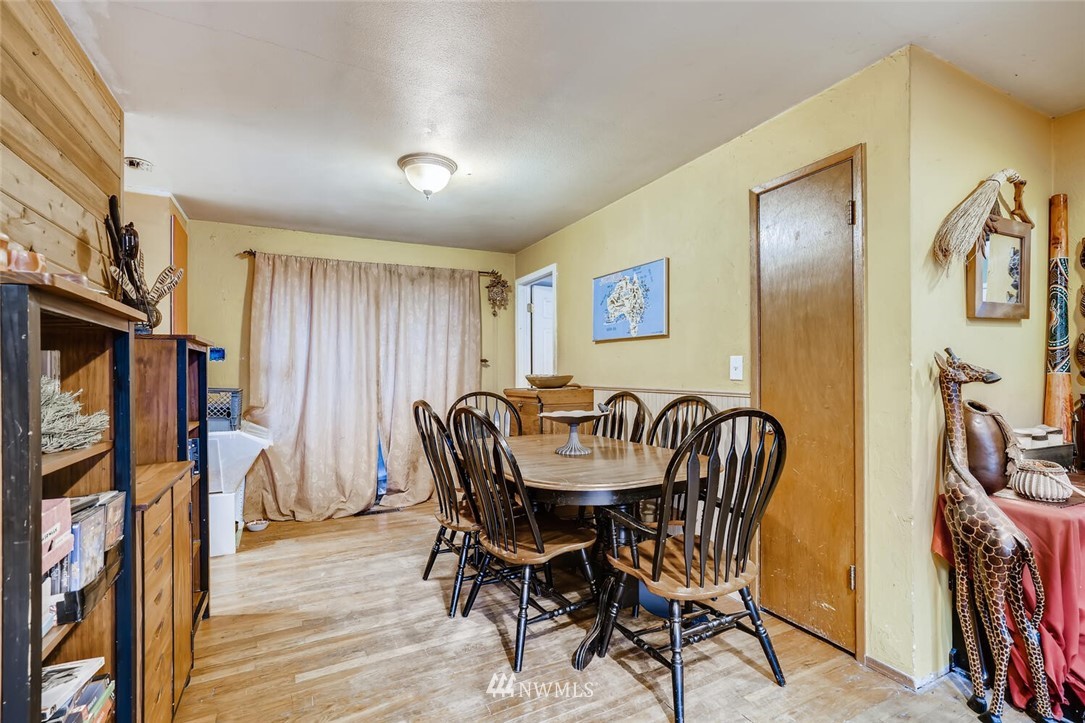 11526 Southeast Petrovitsky Road Renton, WA 98055 - Photo 8 of 28 a view of a a dining room with furniture window and wooden floor