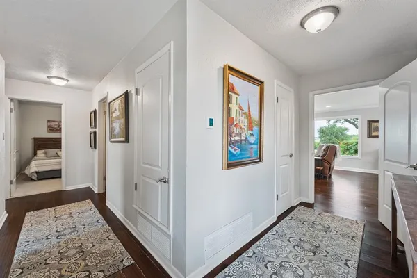 a view of a hallway view with wooden floor and furniture