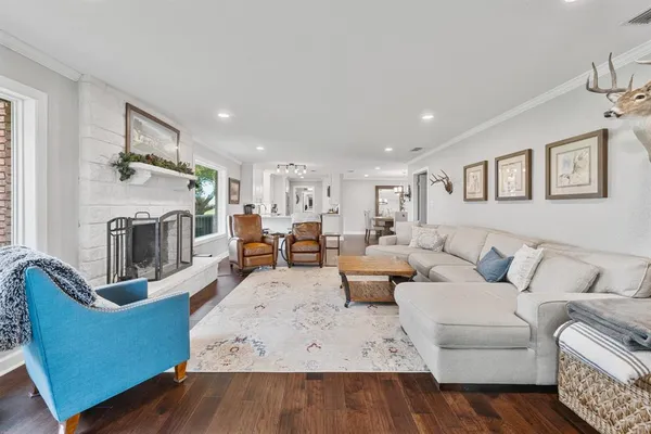 a living room with furniture wooden floor and a fireplace