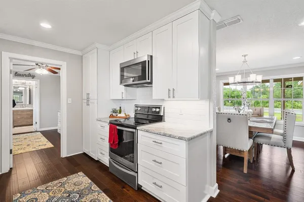 a kitchen with a stove a sink and a refrigerator