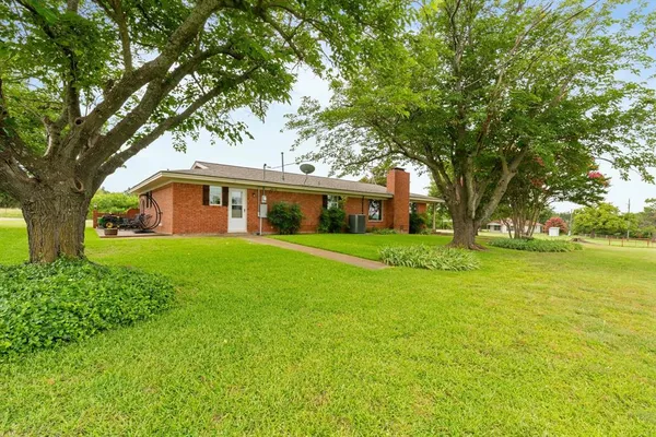 a front view of house with yard and green space