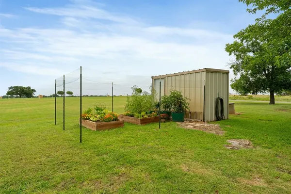 a view of a garden with lawn chairs