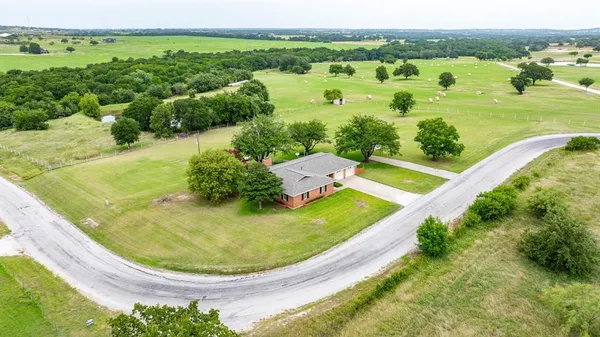 an aerial view of a house with outdoor space swimming pool