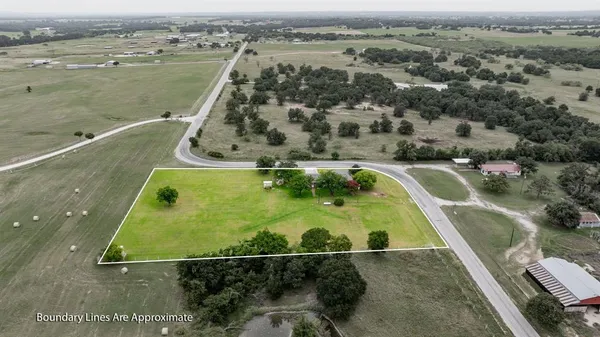 an aerial view of a residential houses with outdoor space