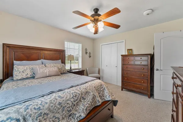 a bedroom with a large bed and a chandelier