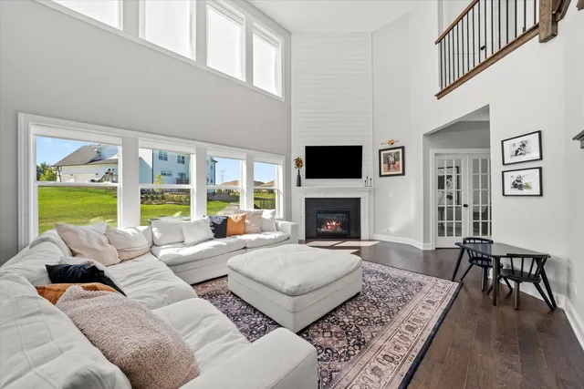 a living room with furniture large window and a fireplace