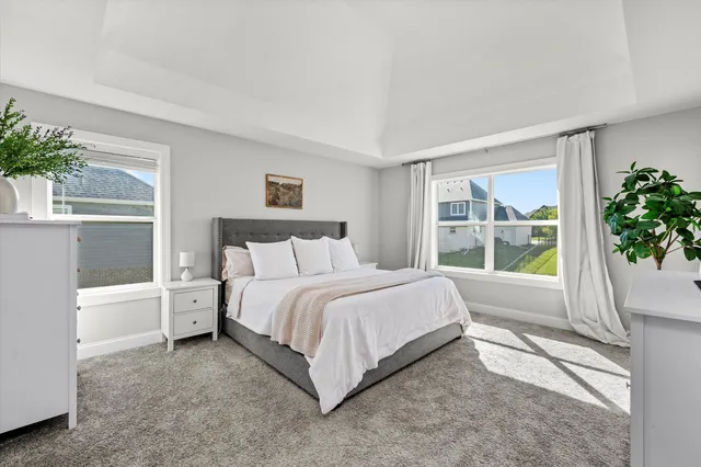 a bed room with a bed and a large window