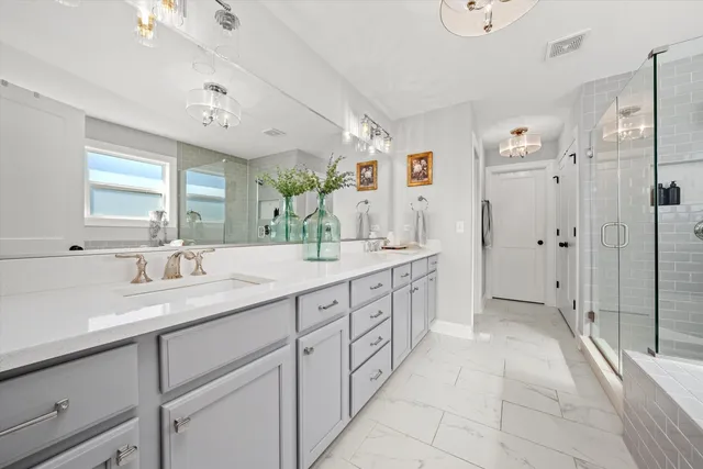 a spacious bathroom with a double vanity sink shower and a mirror