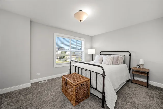 a bedroom with a bed and a night stand