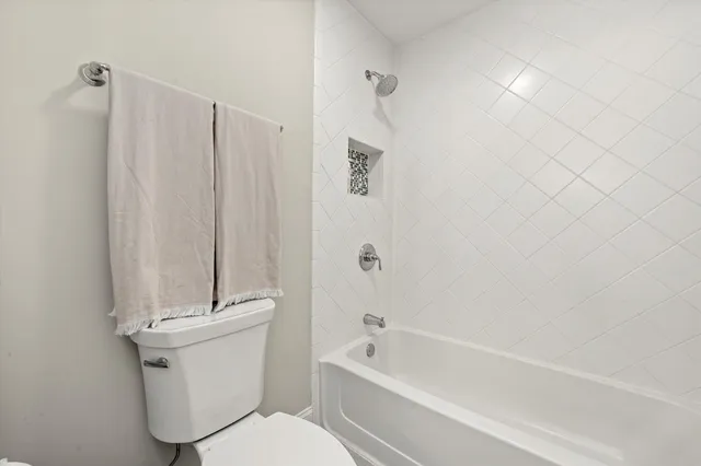 a bathroom with a toilet and a bathtub