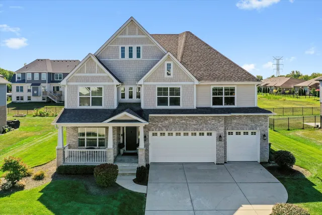 a front view of a house with a yard table and chairs