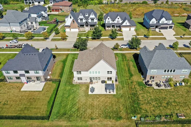 an aerial view of a house with a swimming pool outdoor seating and yard