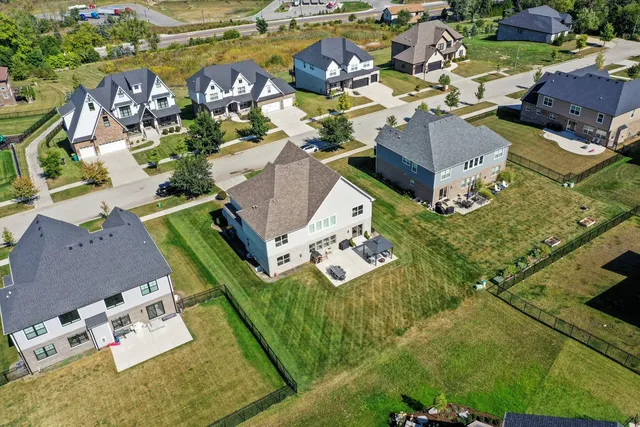 an aerial view of residential house with outdoor space and parking