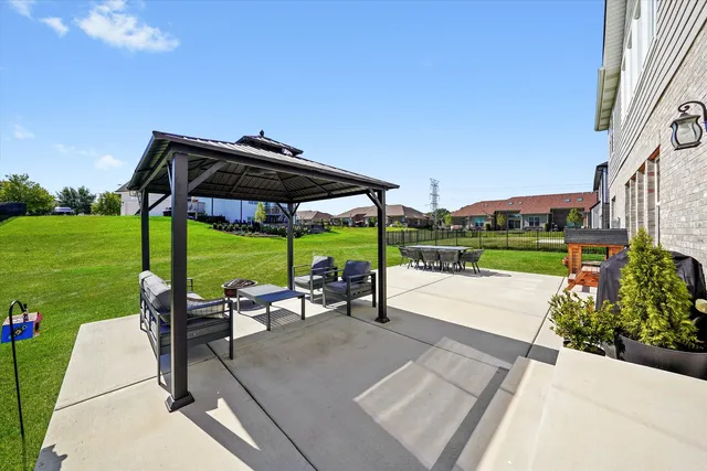 a view of a park with furniture and garden