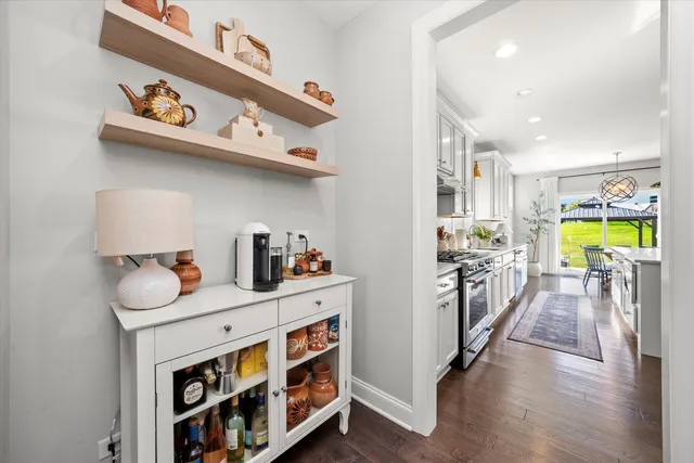 a kitchen with stainless steel appliances granite countertop a lot of cabinets and wooden floor