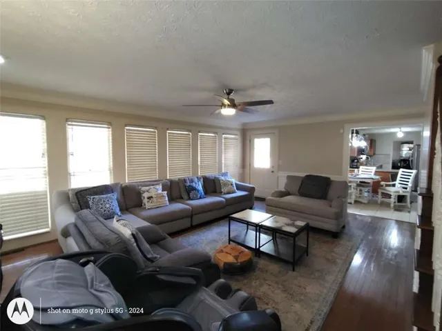 a living room with furniture and stairs