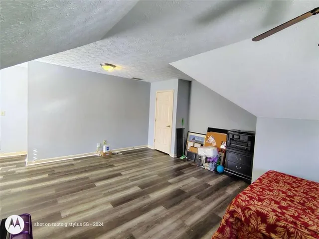 a bathroom with a granite countertop sink a toilet and a mirror