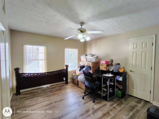 a bathroom with a granite countertop sink a toilet and a mirror