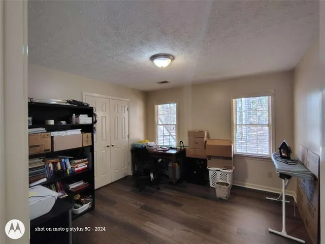 a spacious bathroom with a granite countertop sink and a mirror