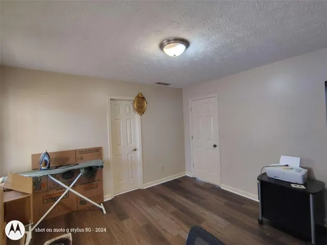 a spacious bathroom with a granite countertop sink and a mirror