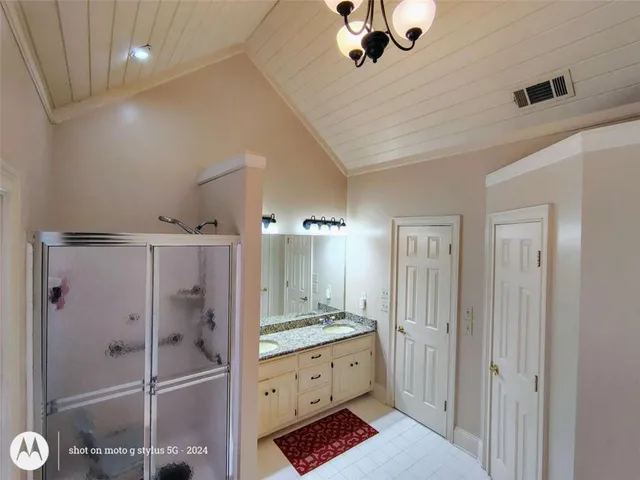 a bedroom with a bed and a dresser with mirror