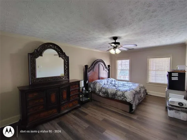 a view of large tree with wooden fence